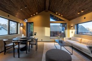 a living room with a couch and a table at Arctic Elegance in Tromsø