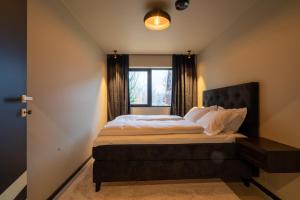 a bedroom with a large bed with a window at Arctic Elegance in Tromsø