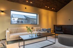 a living room with a couch and a table at Arctic Elegance in Tromsø