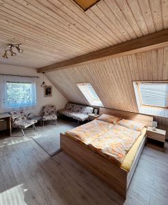 A bed or beds in a room at Chalupa Miška
