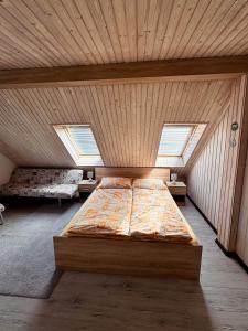 A bed or beds in a room at Chalupa Miška