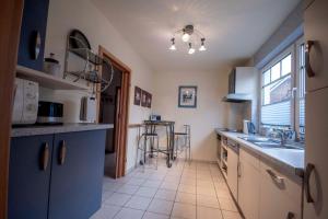 a kitchen with a sink and a counter top at Ferienhaus-Haus-Eversand in Cuxhaven