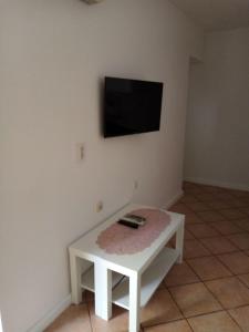 a white coffee table with a television on a wall at Apartments Sab in Povljana