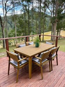 a wooden table with chairs and a potted plant on a deck at Yulo Kopa in Ellenborough +14 photos