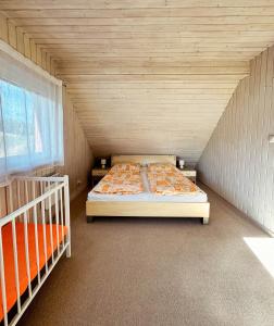 A bed or beds in a room at Chalupa Miška