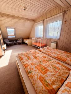 A bed or beds in a room at Chalupa Miška