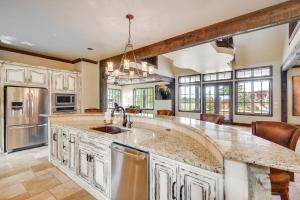 an open kitchen with a large island with a sink at Spacious Edmond Vacation Rental with Hot Tub! in Edmond