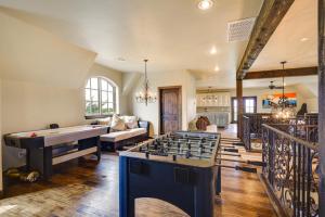 a living room with a pool table and ping pong ball at Spacious Edmond Vacation Rental with Hot Tub! in Edmond +24 photos