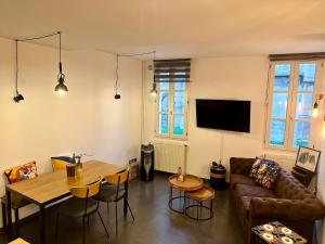 a living room with a couch and a table at Trésors de la Cathédrale, Maison de Ville sur 4 niveaux in Narbonne +22 photos