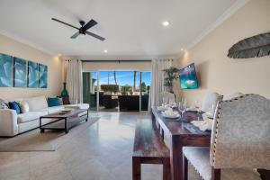 a living room with a table and a couch at Casa Sirena Cabo Poolside Oasis Minutes from Beach in Cabo San Lucas
