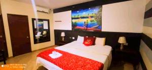 a bedroom with a large bed with a red blanket at HOTEL LUNA Iquitos in Iquitos +19 photos