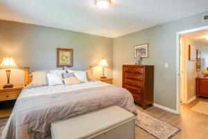 a bedroom with a large bed and a dresser at Pool Access and Lanai Riverfront Welaka Condo! in Georgetown +20 photos