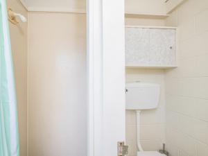 a bathroom with a toilet and a shower at Whanga Bach - Whangamata Holiday Home in Whangamata +22 photos