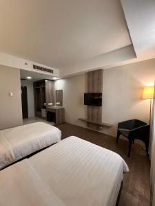 Postel nebo postele na pokoji v ubytování Ajang Hotel