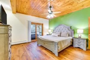 a bedroom with a bed and a ceiling fan at Private Deck and Fire Pit Adirondack Family Home in Old Forge