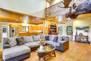 a living room with a couch and a table at Private Deck and Fire Pit Adirondack Family Home in Old Forge