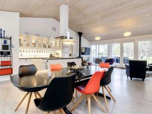 a dining room and kitchen with a table and chairs at 7 person holiday home in Rødby-By Traum in Rødbyhavn