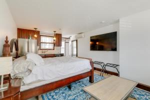 a bedroom with a large bed and a kitchen at Walk to Shore Beachgoers Studio in Ocean City! in Ocean City +4 photos