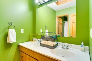 a green bathroom with a sink and a mirror at Private Deck and Fire Pit Adirondack Family Home in Old Forge +30 photos