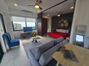 a living room with a couch and a bed at Cómodo Apartamento zona Romántica con alberca 503 in Puerto Vallarta +94 photos