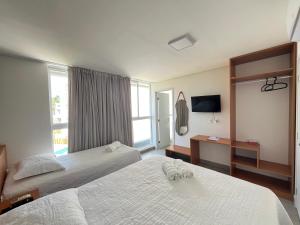 a hotel room with two beds and a window at Casa G9 - Naluum Residence in Passo de Camarajibe +56 photos