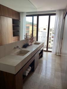 a large bathroom with a sink and a large window at Francisca Luxury Suites - Adults Only in Puerto Vallarta