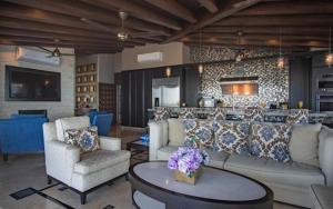 a living room with a couch and chairs and a bar at Pinnacle Resorts at Zona Romantica in Puerto Vallarta