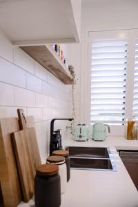 a kitchen with a sink and a counter top at Luxe Altona Haven - Executive 3BR Family Townhouse in Newport