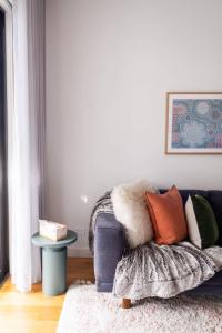 a living room with a blue couch and a table at Luxe Altona Haven - Executive 3BR Family Townhouse in Newport