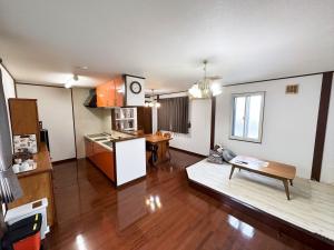 a kitchen and a living room with a table at 森の仲間たち in太子橋 1 丁目 in Osaka