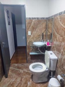 a bathroom with a toilet and a sink at Araucaria in Puerto Esperanza