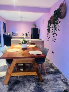 a dining room table with chairs and a purple wall at Casa Lina in Valladolid +25 photos