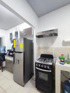 a kitchen with a stove and a refrigerator at KIRAz in Turín