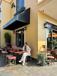 a man sitting at a table outside of a restaurant at Hôtel De Da Phu in Da Lat +89 photos