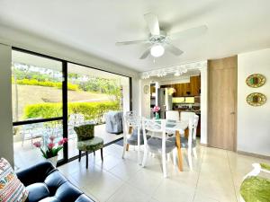 a living room with a ceiling fan and a table and chairs at Vacaciones Eje Cafetero Parque del Cafe WIFI 114C in La Tebaida