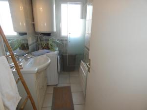 a white bathroom with a sink and a toilet at Notre Dame de Monts (85) - Location Appartement 50m² environ - 6 personnes - FR-1-540-4 in Notre-Dame-de-Monts +28 photos