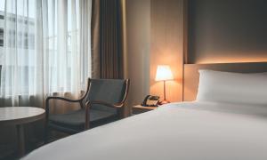 Wonju City Hotel HYEOKSIN客房内的一张或多张床位