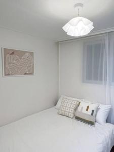 a white bedroom with a white bed with a lamp at Clean & All new - Songridan-gil, Seokchon Lake, Lotte World, KSPO Dome, Olympic Park, Han River, Asan Hospital, Coex in Seoul