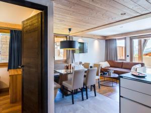 a kitchen and living room with a table and chairs at Appartement 4 pièces aux Saisies avec SPA, parking, accessible PMR - FR-1-810-4 in Les Saisies