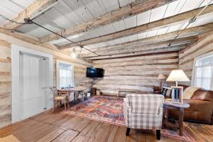 a living room with a couch and a table at Rustic Augusta Cabin in Augusta