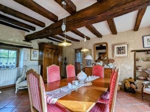 a dining room with a wooden table and chairs at Charmantes chambres d'hôtes avec petit-déjeuner à Azay-le-Ferron - FR-1-591-674 in Azay-le-Ferron +26 photos