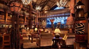 a lobby of a hotel with chairs and chandeliers at Disney's Animal Kingdom Villas - Jambo House in Orlando