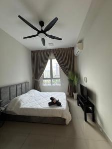 a bedroom with a bed with a ceiling fan at Studio Stay in Kuala Lumpur +5 photos