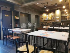 a dining room with two tables and chairs at bangkok bed place in Bangkok