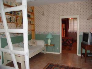 a bedroom with a bunk bed and a television at Chambres élégantes au cœur de la forêt d'Argonne - FR-1-585-138 in Futeau