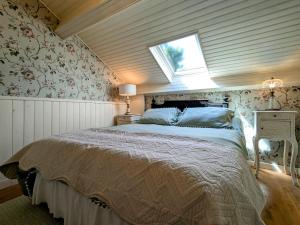 a bedroom with a large bed with a window at Chambre Verte avec Jardin partagé près du Puy-en-Velay - FR-1-582-498 in Rosières