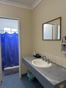 a bathroom with a sink and a mirror at Kalbarri Inn in Kalbarri +29 photos