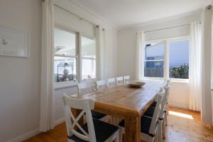 a dining room with a wooden table and chairs at Mary Grant in Port Fairy