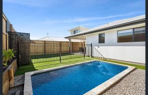 a swimming pool in the backyard of a house at Family-Perfect Home Relax, Swim, Explore, Repeat! in Palmview