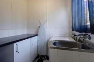 a kitchen with a sink and a counter top at Mary Grant in Port Fairy +10 photos